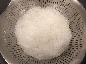 Drain noodles and cut with scissors